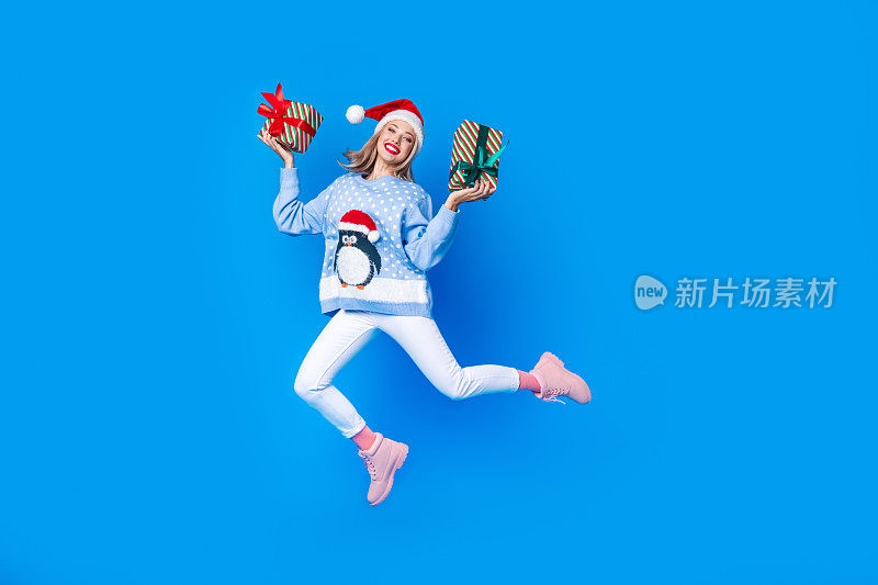 Full body cadre of jumping with two gift boxes girl invite brochure shopping mall new year atmosphere isolated on blue color background